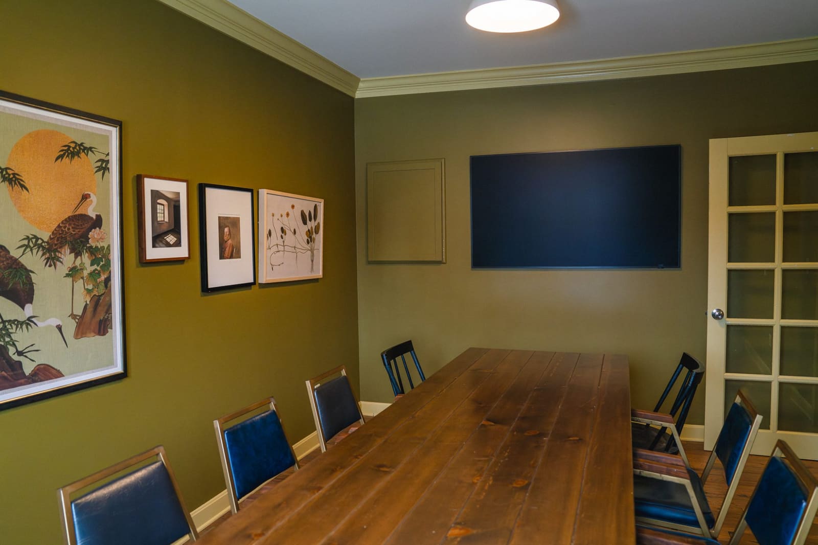 The upstairs conference room at Pearson’s, with a long wood table set for ten